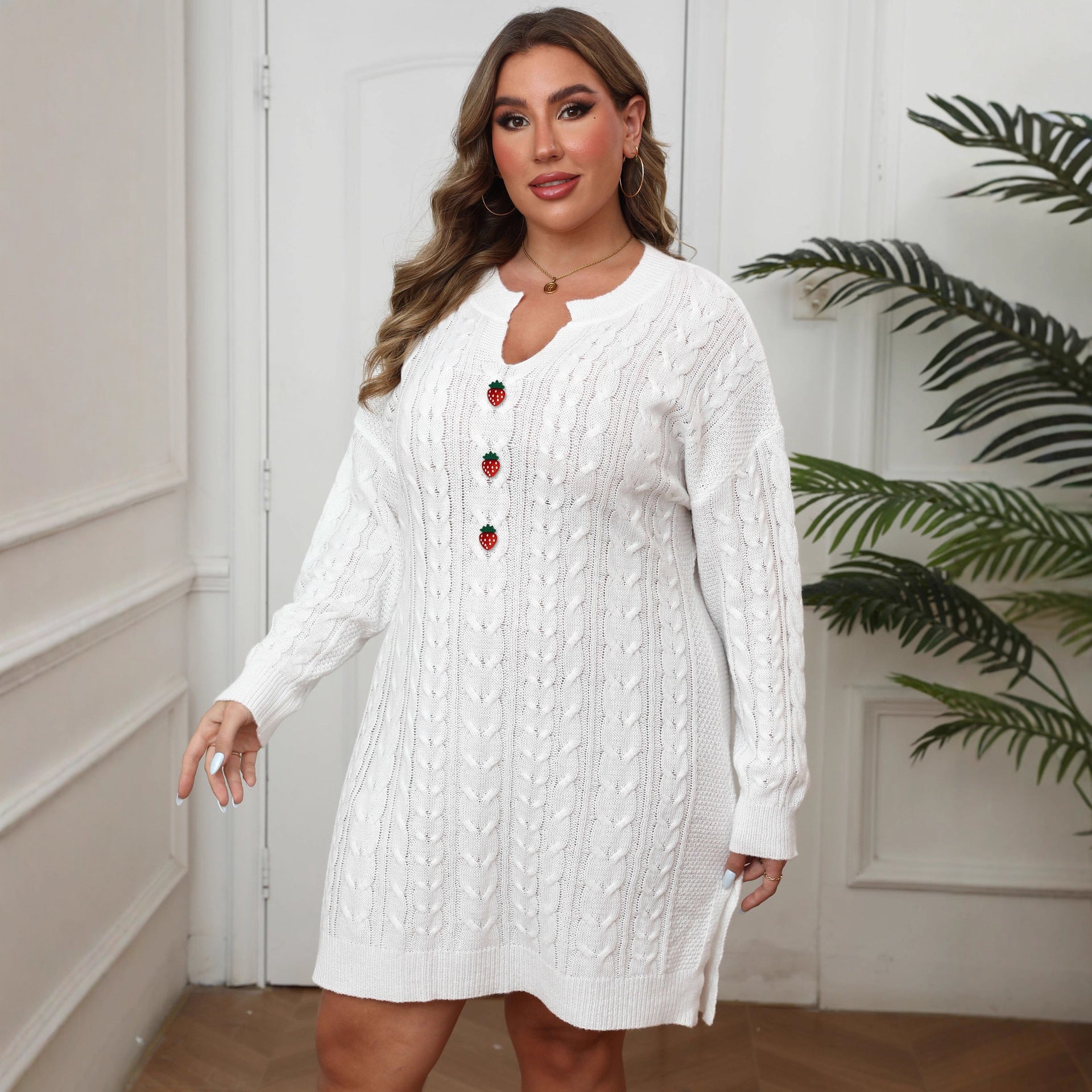 White cable-knit plus size dress with long sleeves, V-neck, and strawberry button details