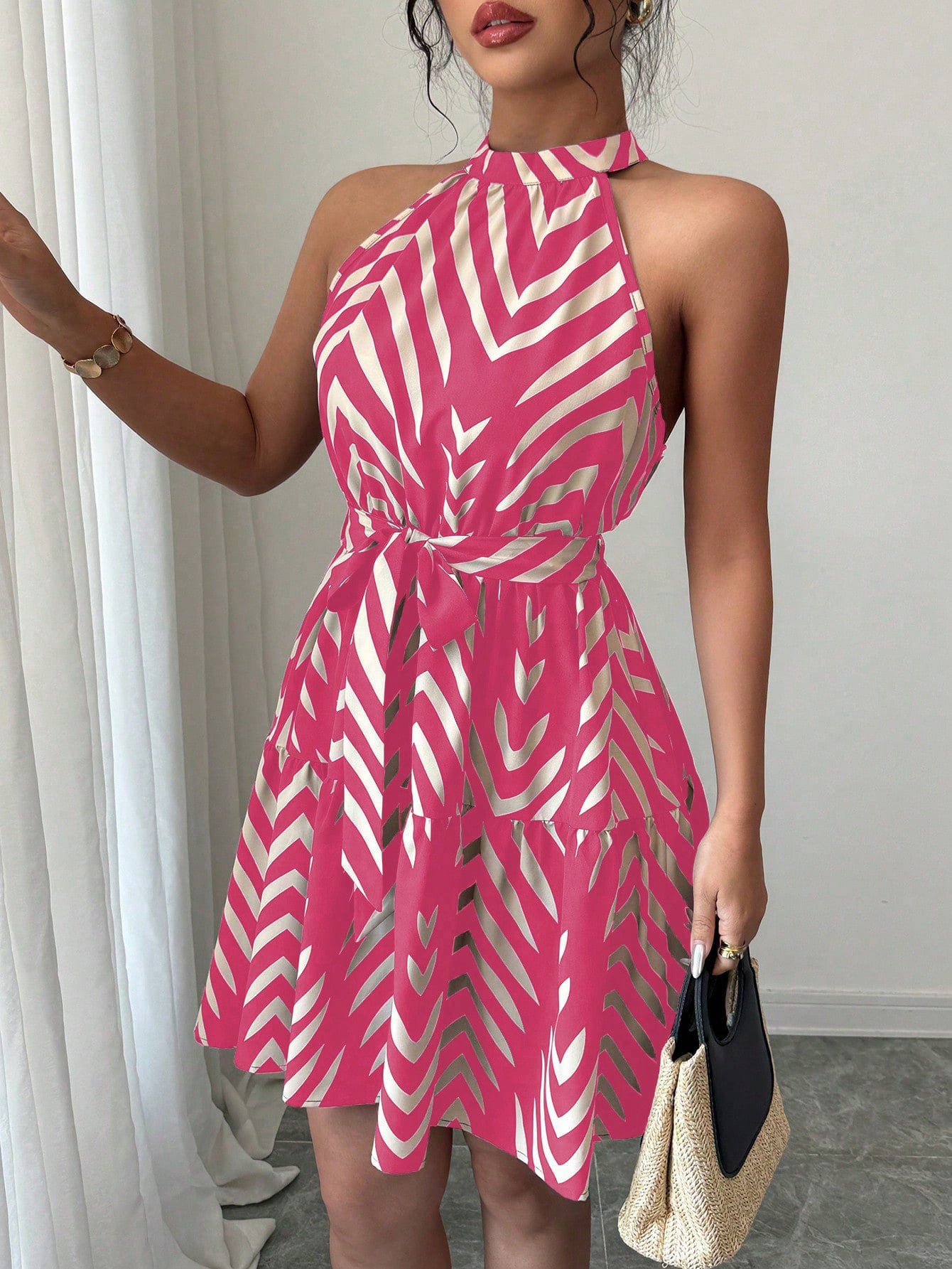 Striped halter dress in coral pink and white zigzag print with cinched waist