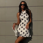 Polka dot satin halter mini dress, sleeveless, fitted waist, black dots on white