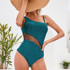 Teal textured one-piece swimsuit with thin straps, side cutout, high-leg coverage
