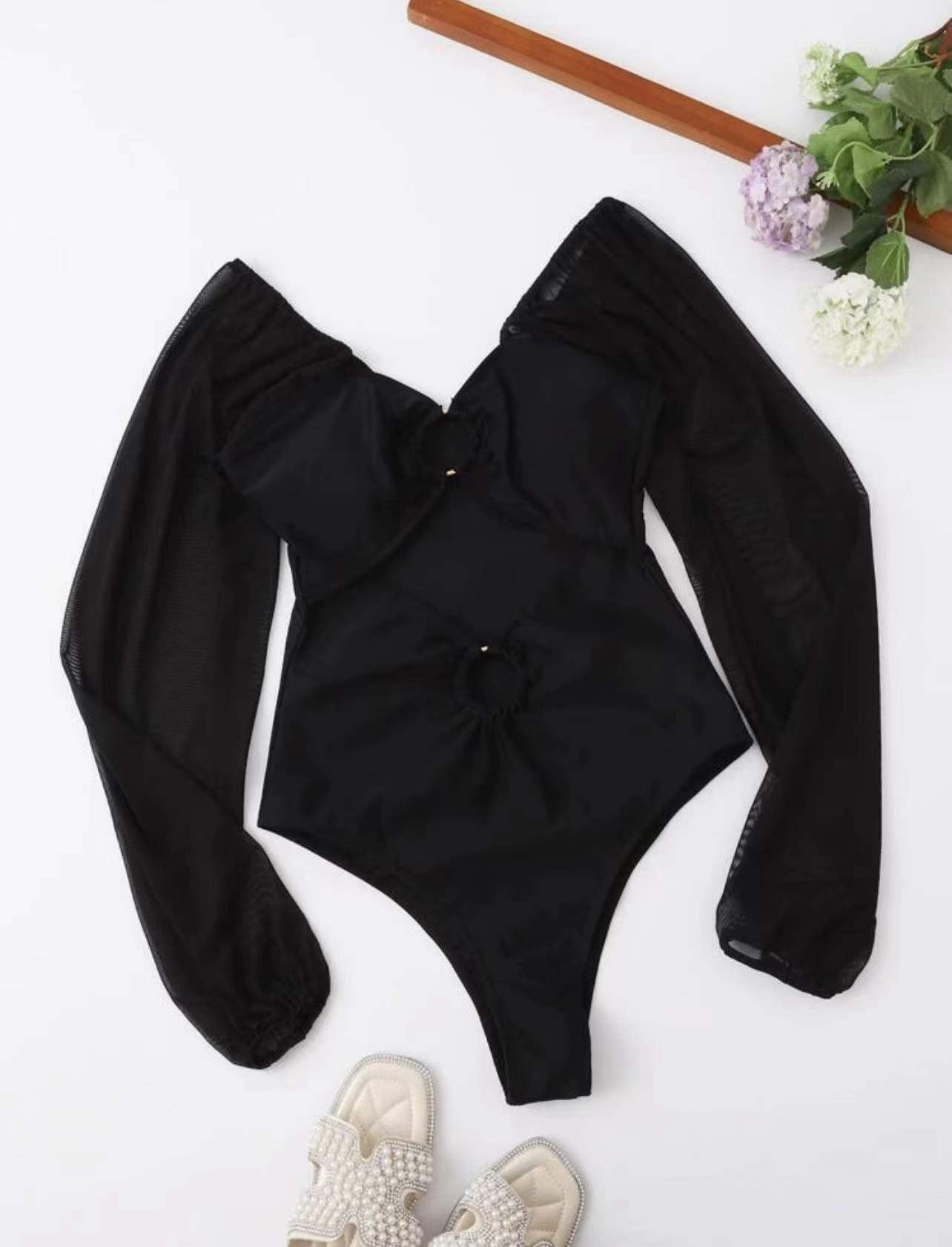 Black one-piece swimsuit with front knotted ring detail and sheer long sleeves