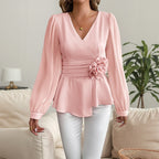 Pink V-neck blouse with puff sleeves, flower waist detail, peplum hem
