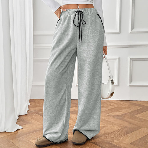Gray high-waist wide-leg sweatpants with black drawstring and contrast hem trim