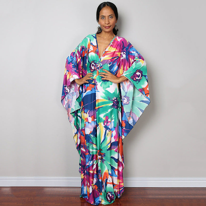 Colorful one-piece beach swim dress with V-neck, flowy maxi drape and tropical floral print
