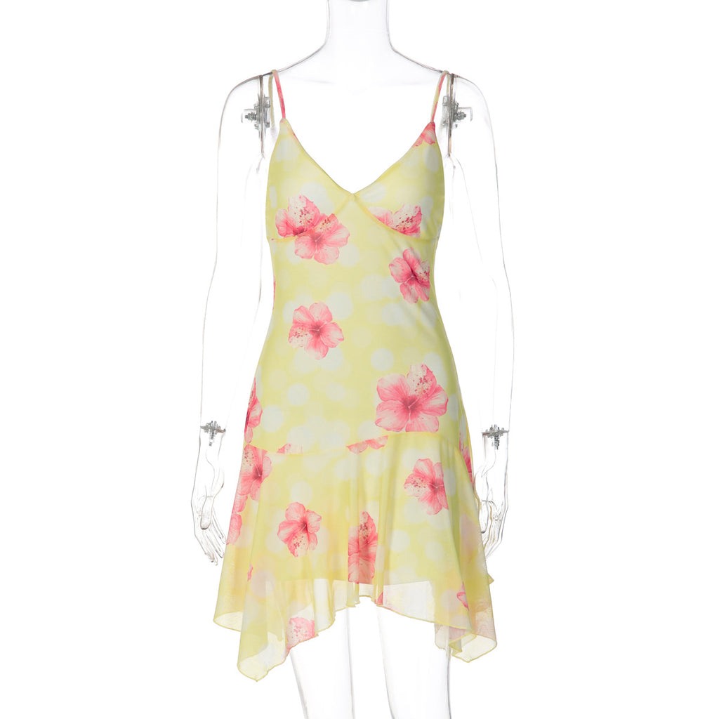 Yellow floral summer dress on mannequin with thin straps, V-neck, and layered ruffled hem