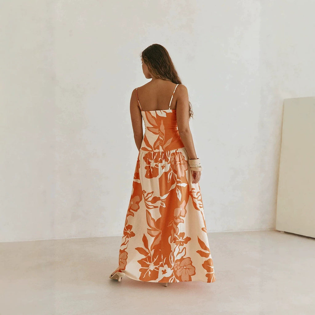 Back view maxi floral dress in orange and white with spaghetti straps