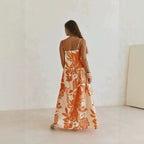 Back view maxi floral dress in orange and white with spaghetti straps