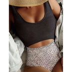 Dark one-piece swimsuit with ribbed scoop neckline and high-leg cut