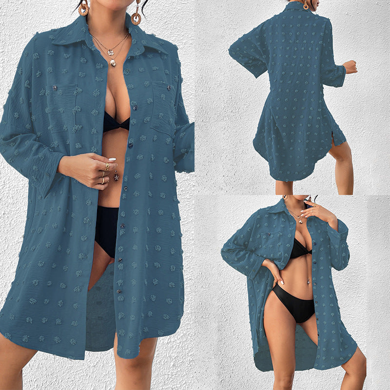 Teal button-up swim cover-up tunic over black one-piece swimsuit, long sleeves