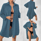 Teal button-up swim cover-up tunic over black one-piece swimsuit, long sleeves