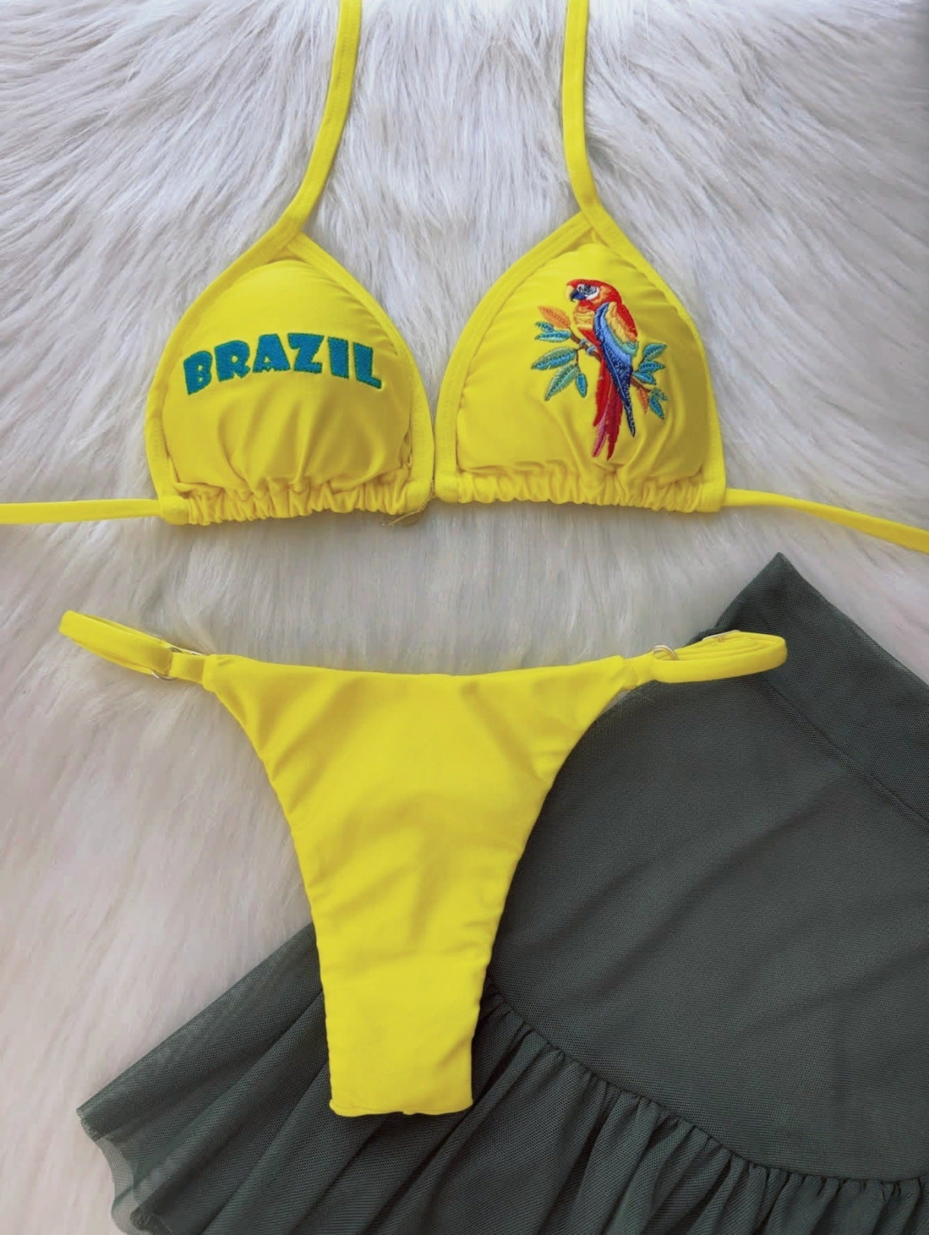 Yellow triangle bikini swimwear with 'BRAZIL' lettering and colorful bird embroidery