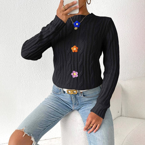 Black cable-knit pullover sweater, round neck, long sleeves, vertical flower appliques