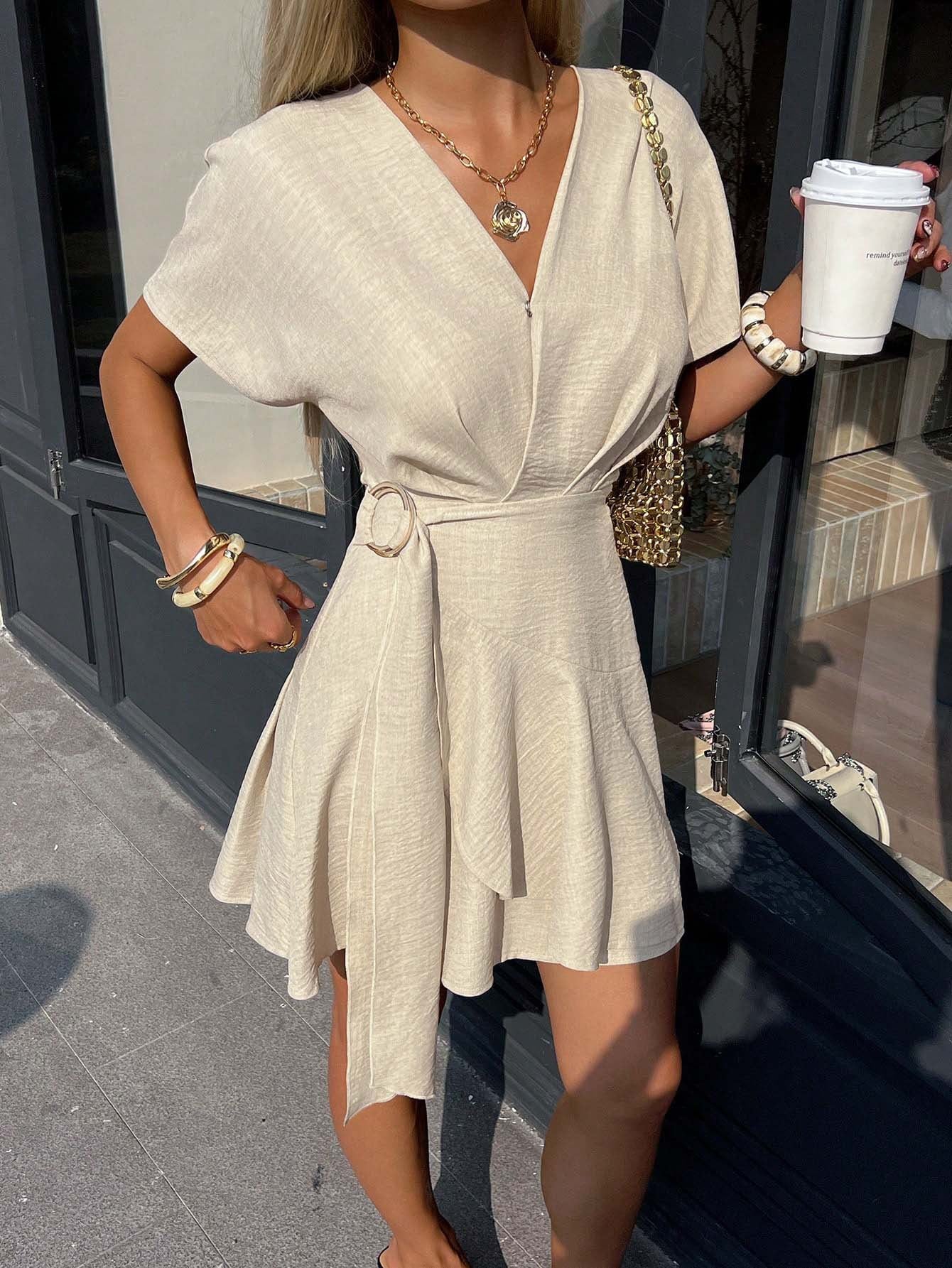 Light beige V-neck mini dress with short sleeves, waist tie, and gathered skirt