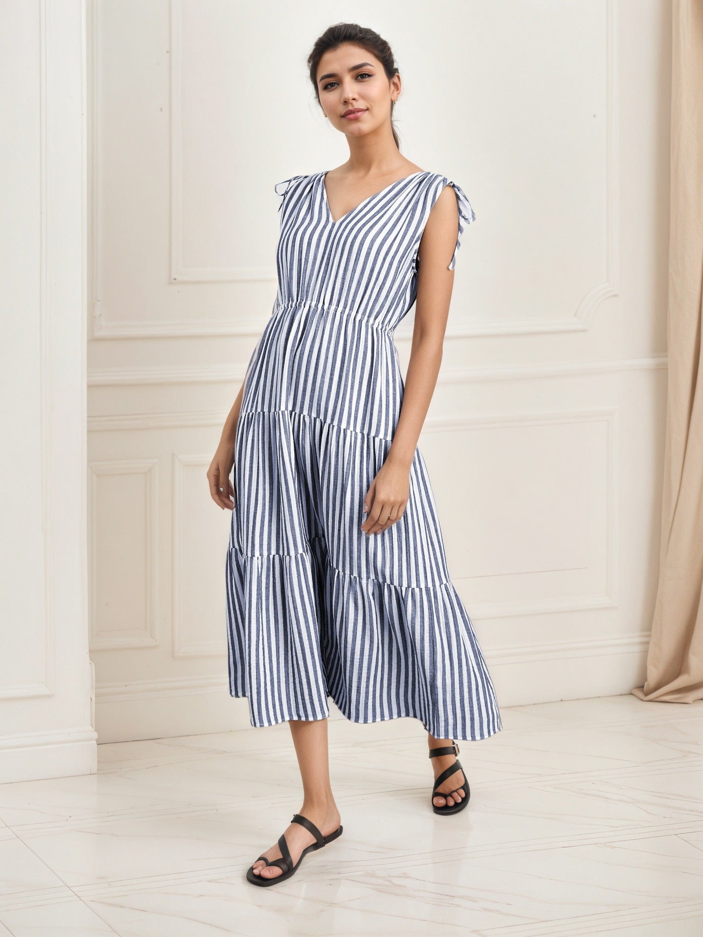 Blue-and-white striped sleeveless midi dress with tiered layers and V-neck