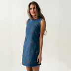Blue denim sleeveless vest with red and green embroidery, side view, straight hem
