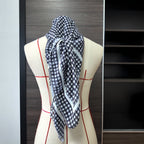 Black-and-white plaid one-piece swimwear with matching scarf draped