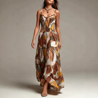Multi-color sleeveless maxi dress with abstract print, smocked bodice, layered pleats