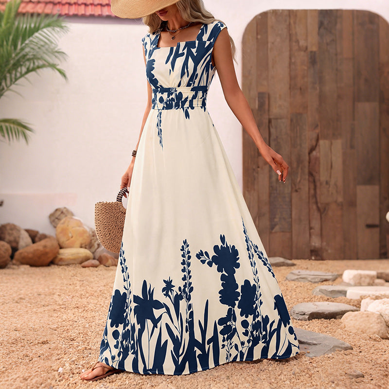 Sleeveless maxi dress with blue-and-white botanical print, fitted bodice, flowy A-line