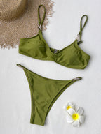 Green bikini swim set with triangle top and high-cut bottom laid flat