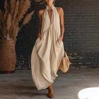 Beige sleeveless halter maxi dress with deep V neckline and gathered waist