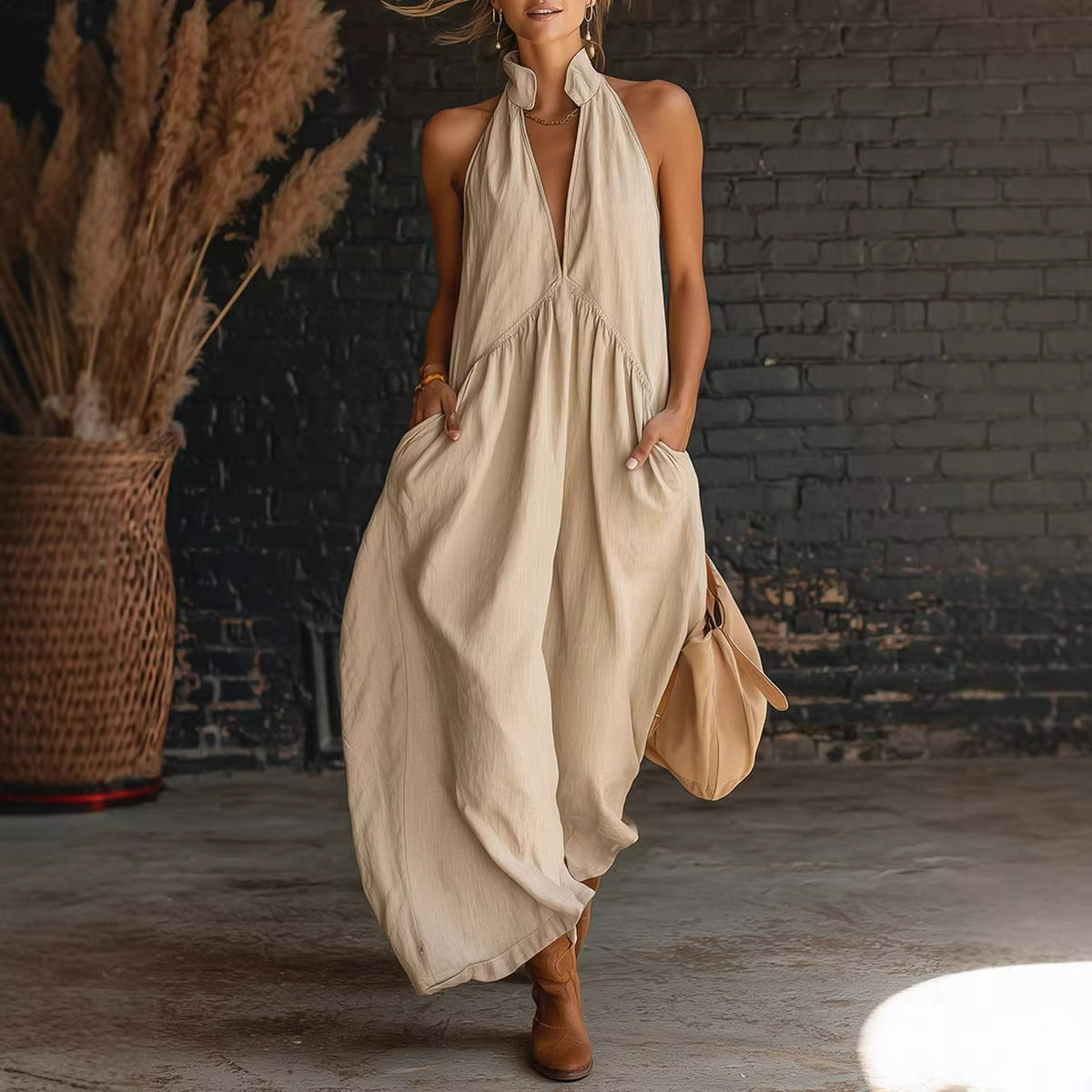 Beige sleeveless halter maxi dress with deep V neckline and gathered waist