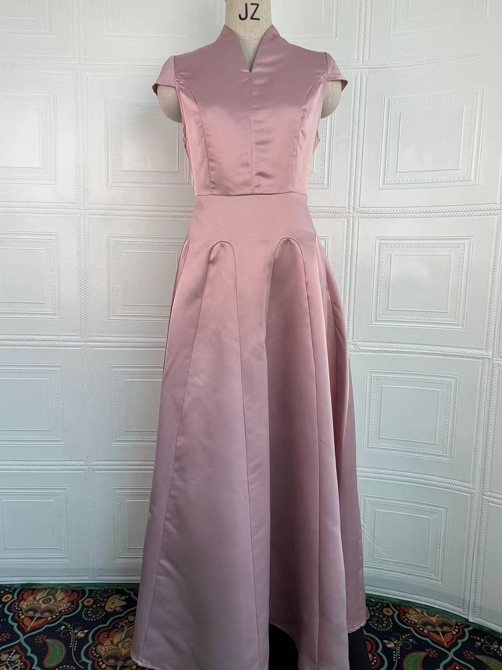 Light pink sleeveless-looking short-sleeve dress with fitted waist and pleated skirt