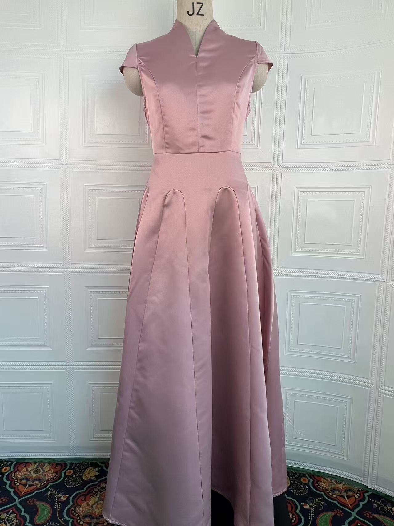 Light pink sleeveless-looking short-sleeve dress with fitted waist and pleated skirt