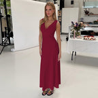 Burgundy sleeveless midi dress with V-neck, fitted bodice, and flowing skirt