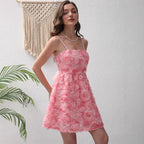 Pink ruffled mini summer dress with spaghetti straps and cinched waist.