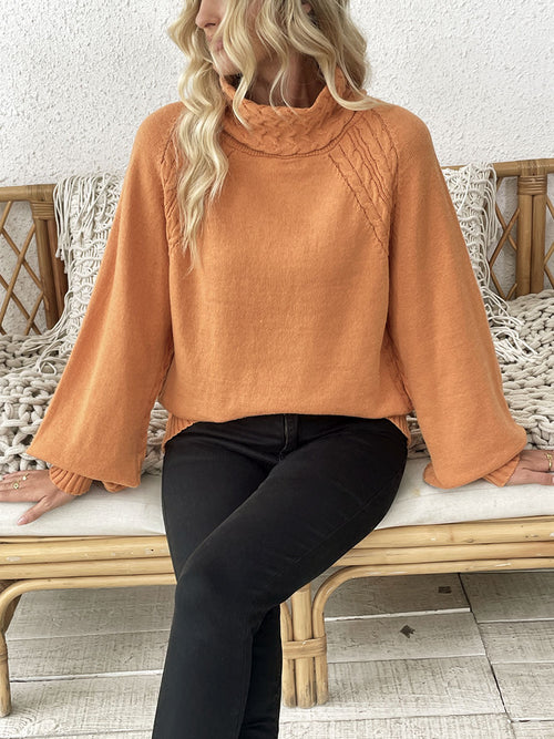 Orange sweater with half turtleneck and textured knit pattern, flared sleeves