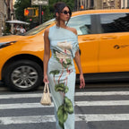 Light blue sheath summer dress with one shoulder and green floral print, side view