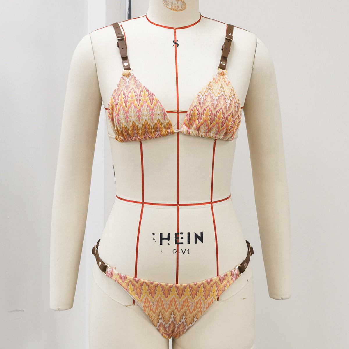 Patterned one-piece swimsuit with adjustable shoulder straps, V-neck and cheeky cut