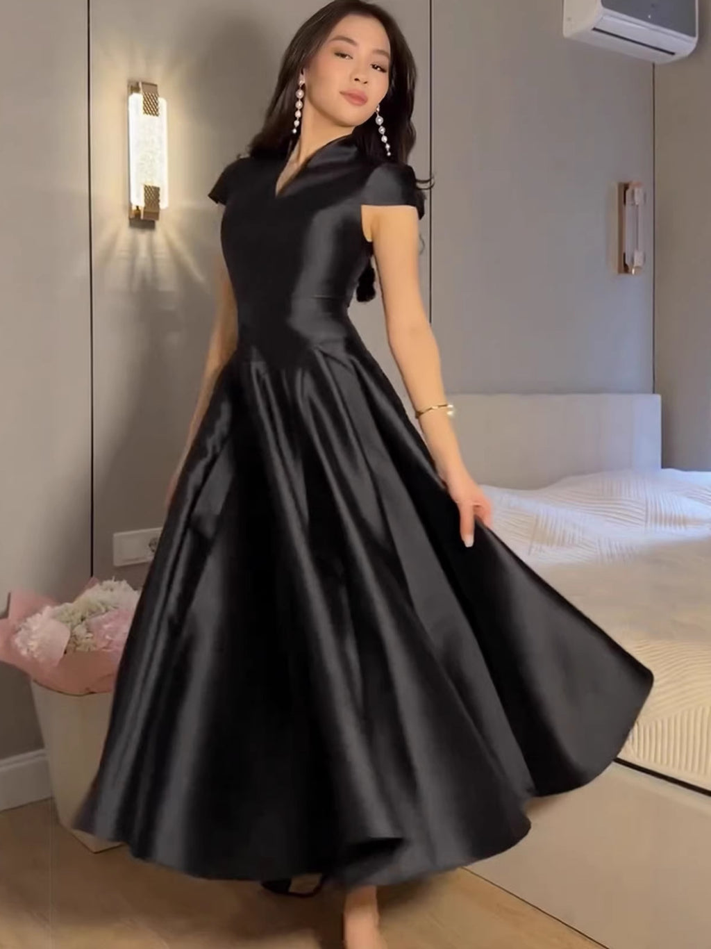 Black short-sleeve fit-and-flare dress with V-neck and full pleated skirt