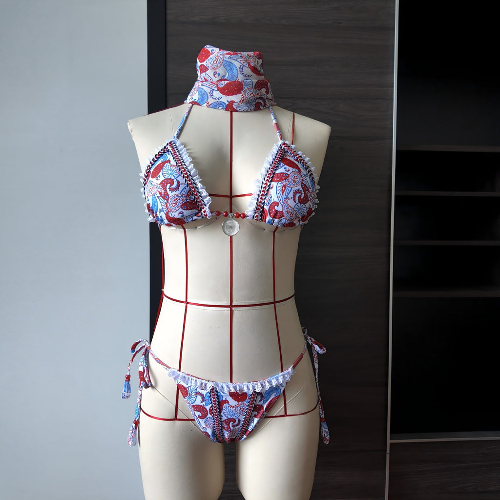 Printed lace bikini set on mannequin with wide-brim tie top, lace edging, red-and-blue print