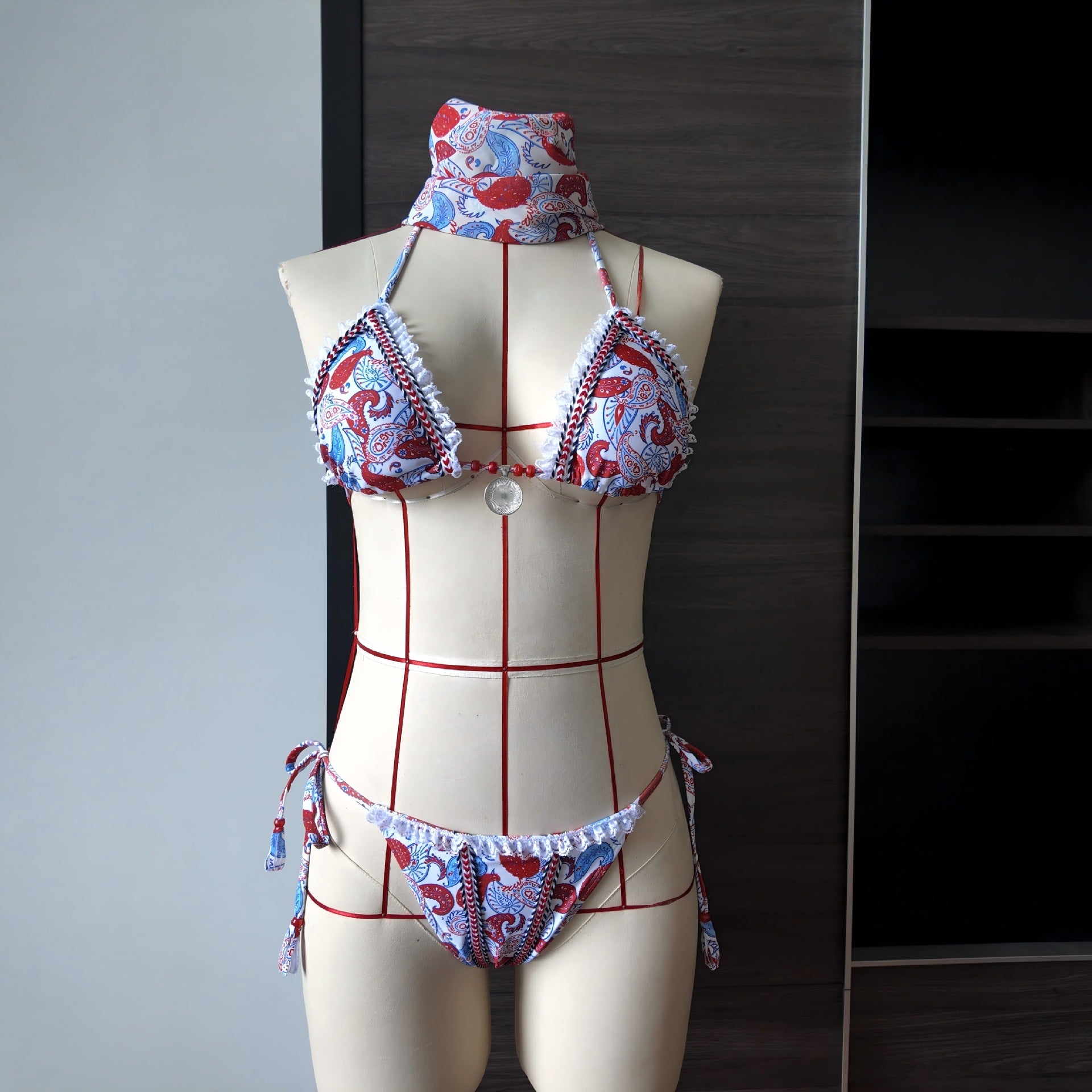 Printed lace bikini set on mannequin with wide-brim tie top, lace edging, red-and-blue print