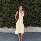 Apricot halter midi dress with scoop neckline and softly gathered skirt