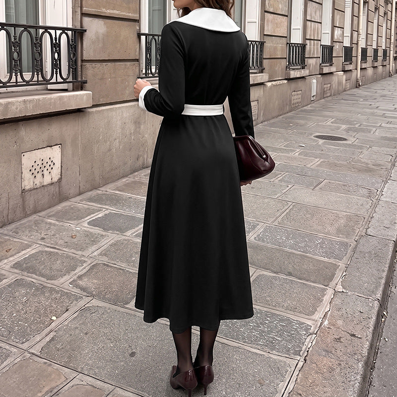 Black midi dress back view with white collar trim, long sleeves, waist belt