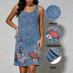 Blue denim sleeveless sling dress with front pocket and colorful floral embroidery