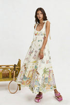Women's sleeveless printed maxi dress, off-white with colorful graphics, bow-tie shoulder straps