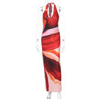 Women’s halter maxi dress on mannequin, red-orange abstract pattern, open back