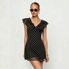 Black polka dot mini dress with ruffled V neckline and short flutter sleeves