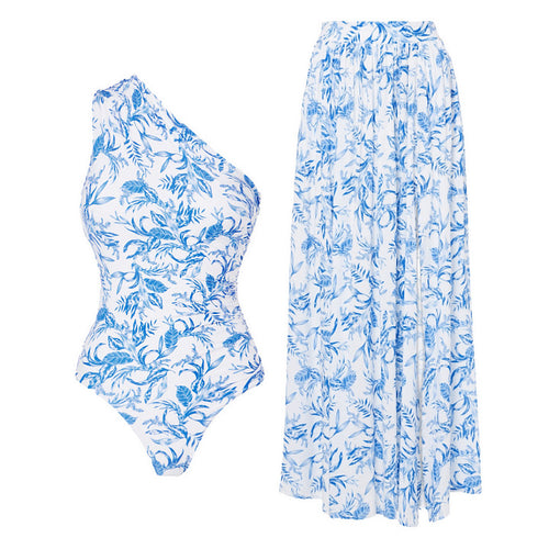 Asymmetric one-shoulder swimsuit and matching blue floral wrap skirt set