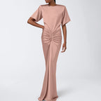 Pink satin sheath dress with short sleeves, ruched waist knot, long column silhouette