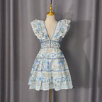 Blue-and-white floral sundress with deep V-neck, ruffled sleeves, and tiered lace hem