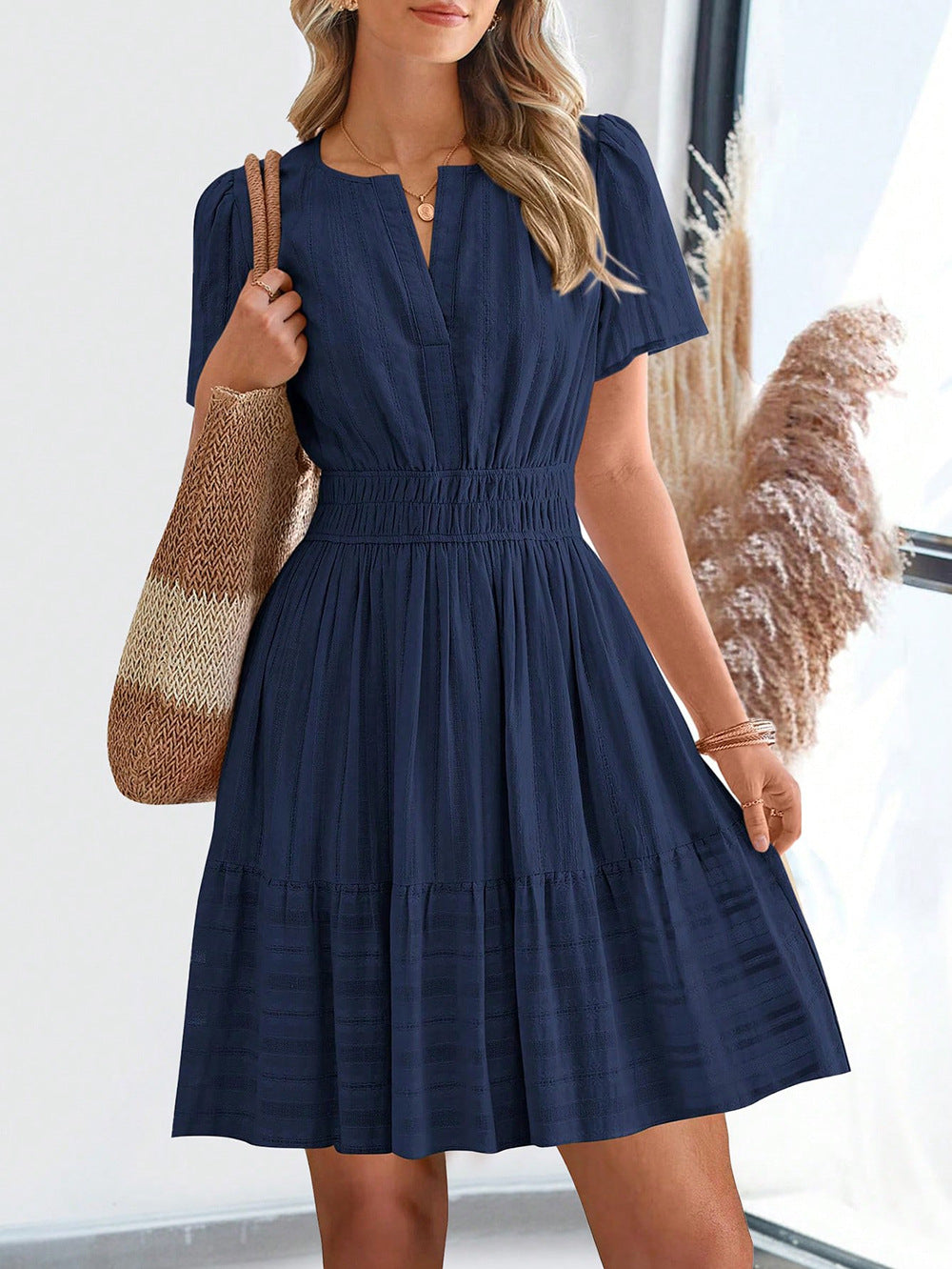 Navy short-sleeve summer dress with V-neck and gathered tiered skirt