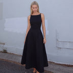 Black backless cami dress with wide skirt and halter straps, sleeveless design