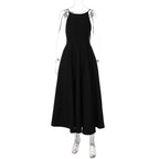 Black backless cami dress on mannequin, flared midi skirt and thin tie straps