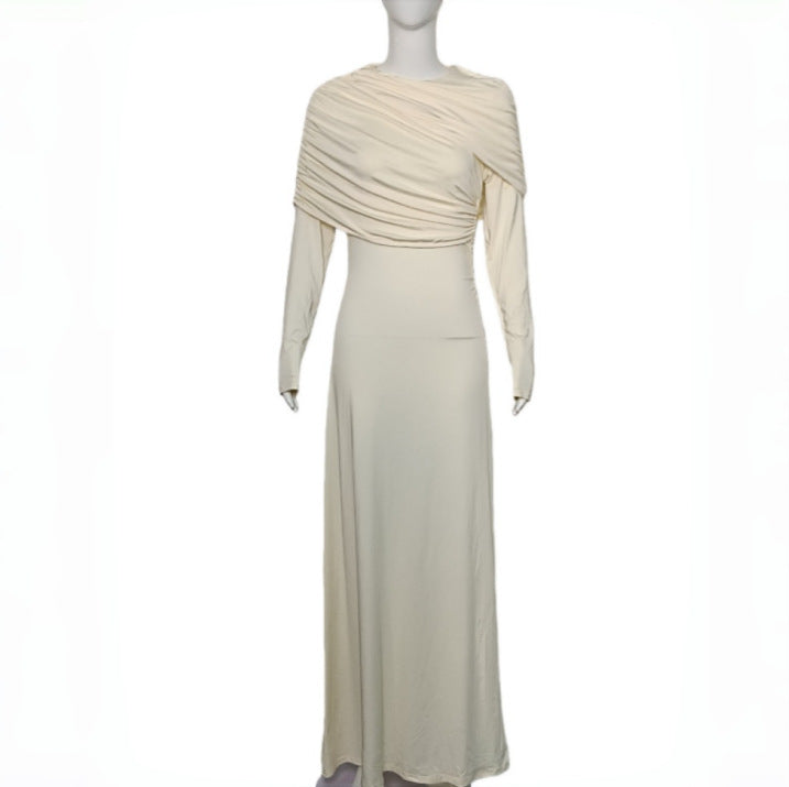 Light apricot pleated spring dress on mannequin, draped neckline, fitted waist, long sleeves