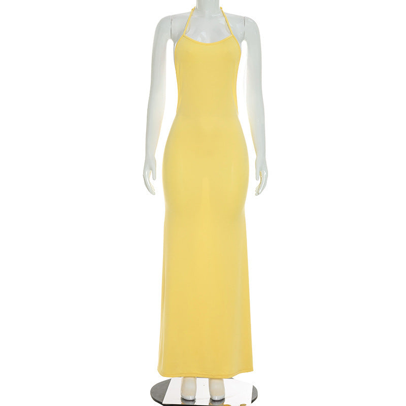 Yellow backless maxi dress on mannequin with spaghetti straps and scoop neckline.