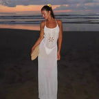 White crochet beach dress with spaghetti straps and openwork floral pattern